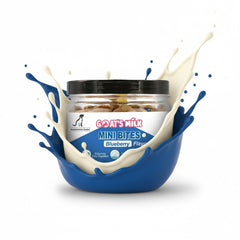 Jar of 'Goat's Milk Mini Bites' with blueberry flavor surrounded by splashes of milk on a white background