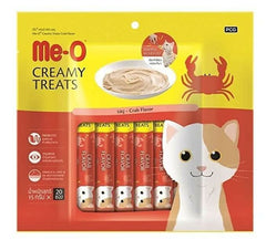 Packaging of me-o creamy treats for cats with a crab flavor, featuring cartoon cat illustrations on a yellow and red background.