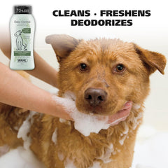 Dog being bathed with a bottle of Wahl shampoo labeled 'Odor Control' on a white background.