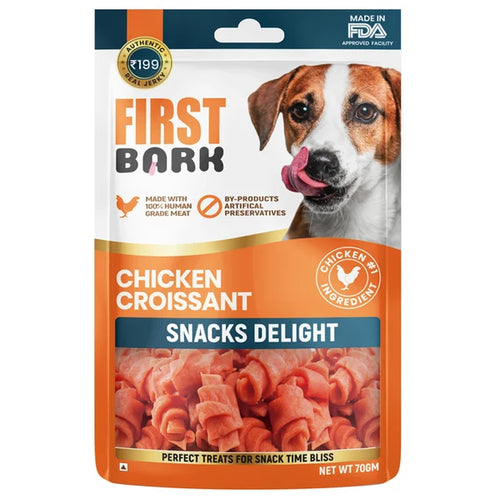 Dog treat package labeled 'First Bark' with a chicken croissant snack on a white background