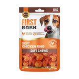 A package of First Bark Soft Chicken Ring Soft Chews dog treats, featuring a brown and orange bag with a photo of a dog on the front and a clear window showing the orange chews inside.