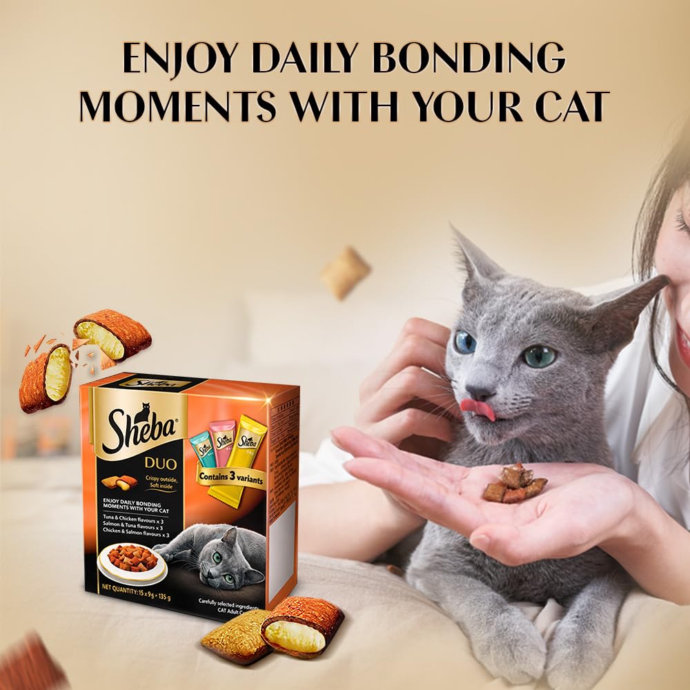 Person holding a Sheba Duo cat food packet with a cat eating from their hand, text 'Enjoy daily bonding moments with your cat'.