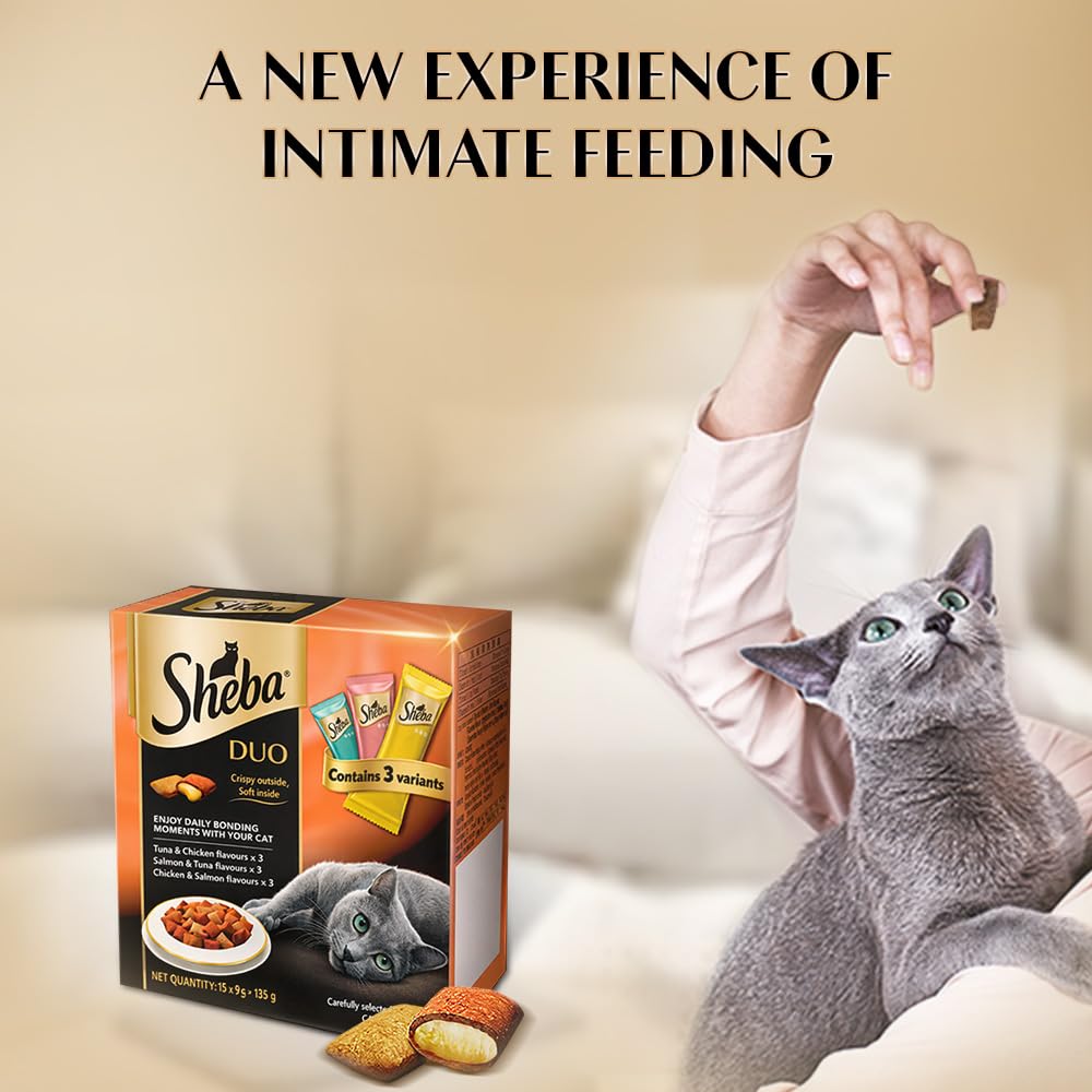Sheba Duo cat food packaging with a cat looking at it, on a blurred background.
