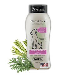 Wahl flea and tick shampoo bottle with rosemary and cedar leaves on a white background