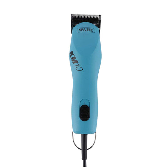 Groomer using a corded grooming tool on a dog.