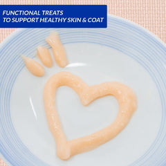 Pet food treat shaped like a heart and paw on a plate with text about supporting healthy skin and coat.