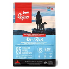 Orijen dog food package with a silhouette of a person and dog on a mountain background